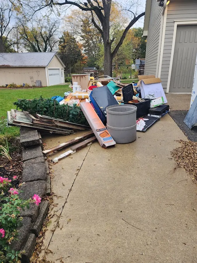Dumpster being loaded with debris for Roofing Dumpster Rental in Pompey